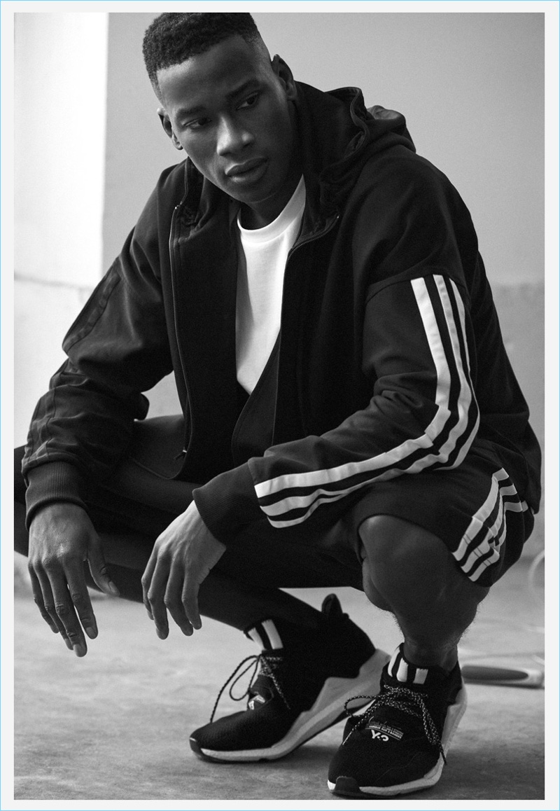 David Agbodji wears a Y-3 classic tee, Saikou sneakers, stripes hoodie, and shorts.