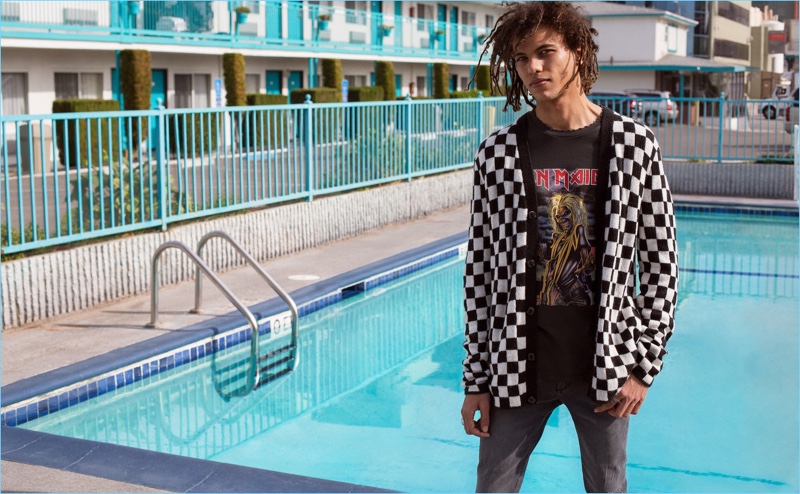 Roberto Rossellini rocks a checkerboard print cardigan with skinny jeans and an Iron Maiden t-shirt from H&M.