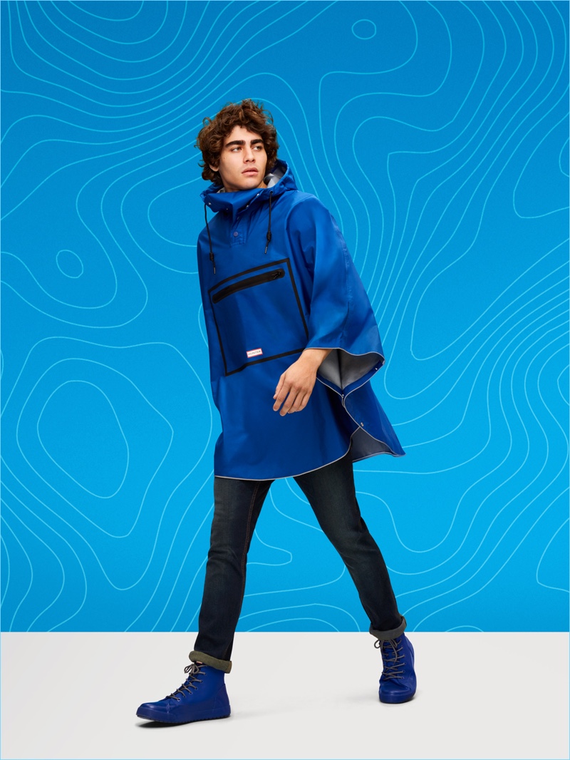 Francisco Perez wears a poncho and boots from Hunter's Target collaboration.