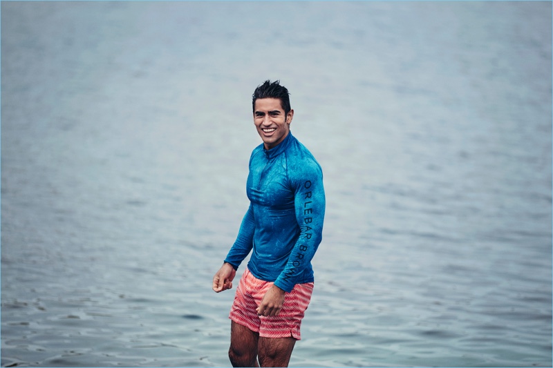 All smiles, Jeremy Jauncey wears Orlebar Brown's Bulldog Sport swim shorts in its berry Alara print.