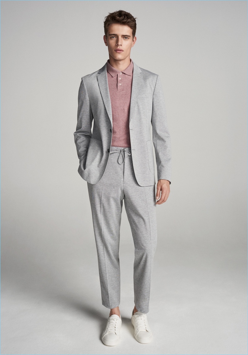 Dressed in grey, Jordy Baan wears a suit for John Lewis' spring 2018 campaign.