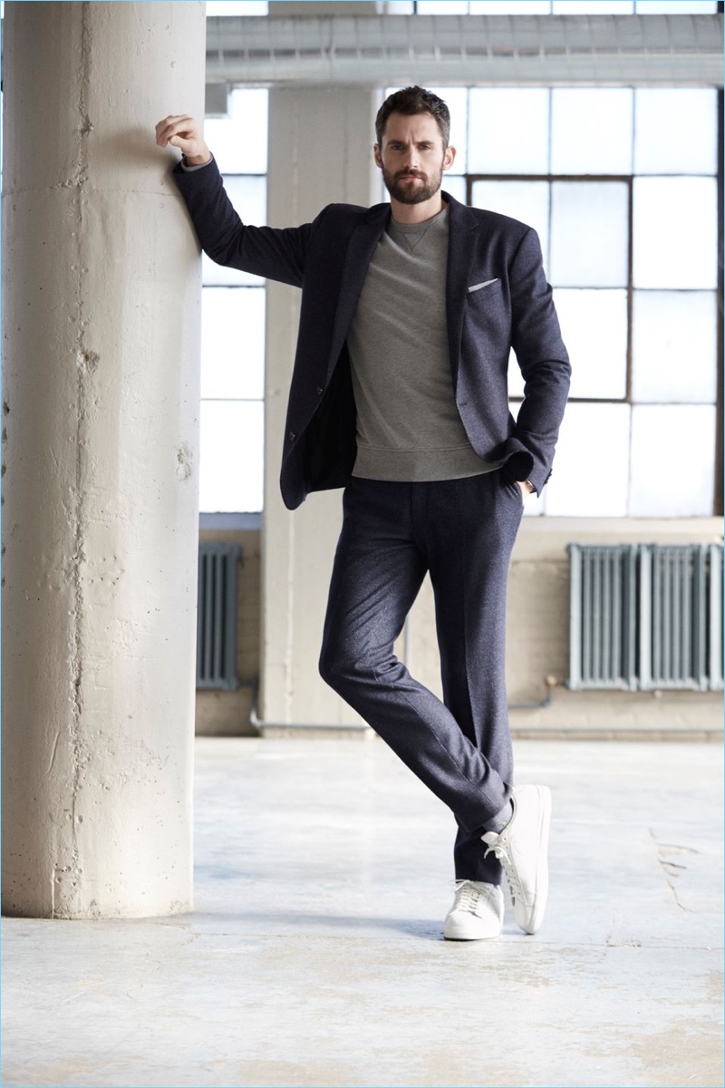 Embracing a contemporary look, Kevin Love wears a Banana Republic suit with sneakers and a sweatshirt.