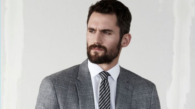 Kevin Love dons a grey suit by Banana Republic.