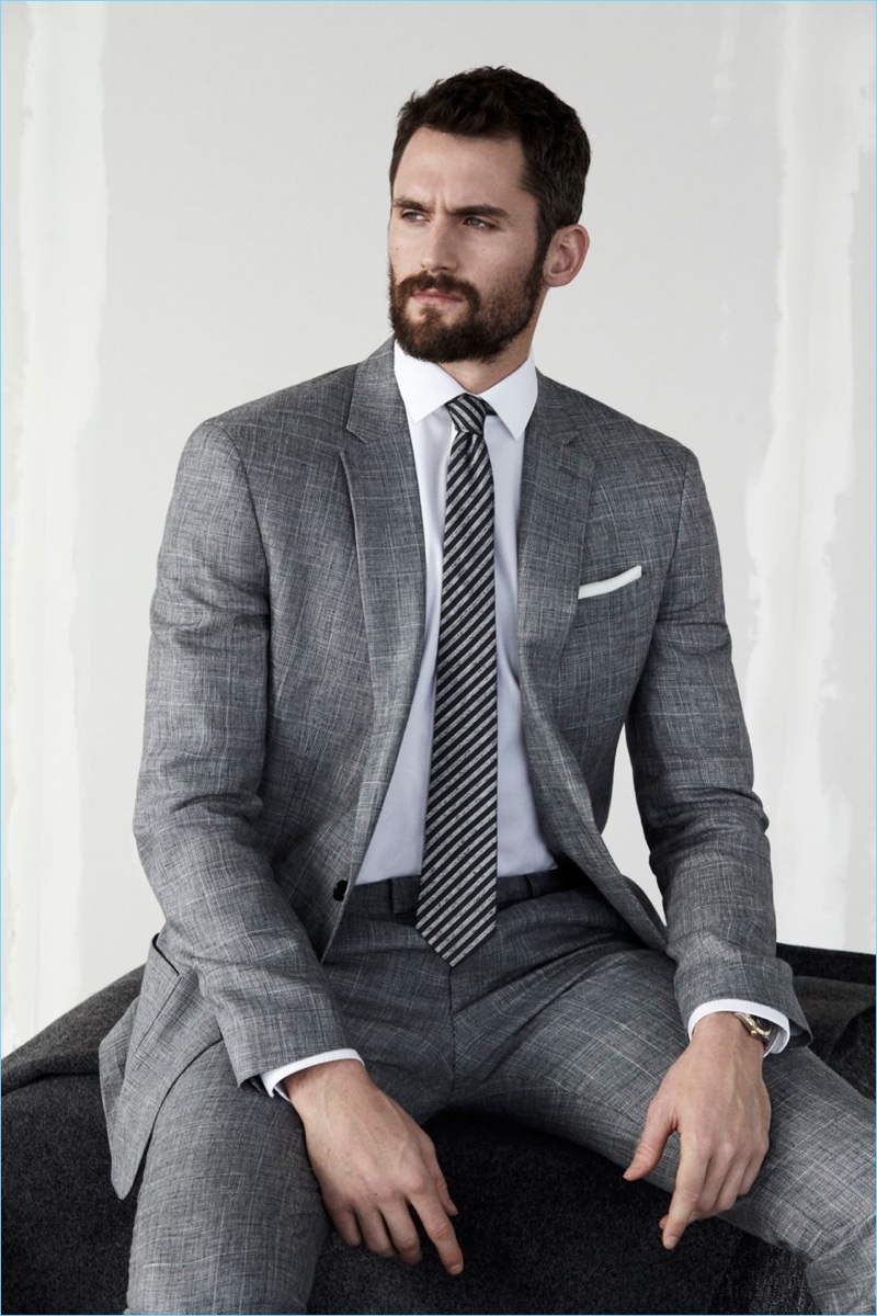 Kevin Love dons a grey suit by Banana Republic.