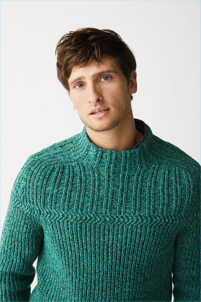 Tom Warren models a green sweater from Marc O'Polo's fall-winter 2018 range.