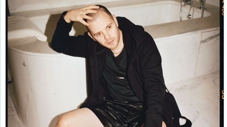 Retreating indoors, Mike Skinner rocks a Reigning Champ hooded robe, Saint Laurent t-shirt, Gucci satin shorts, and Tom Ford leather slides.