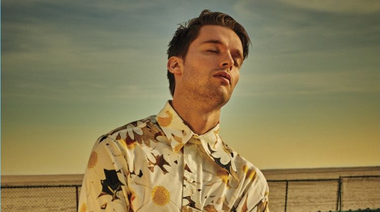 Basking in the sun, Patrick Schwarzenegger wears an Alex Mullins shirt and Lanvin pants.