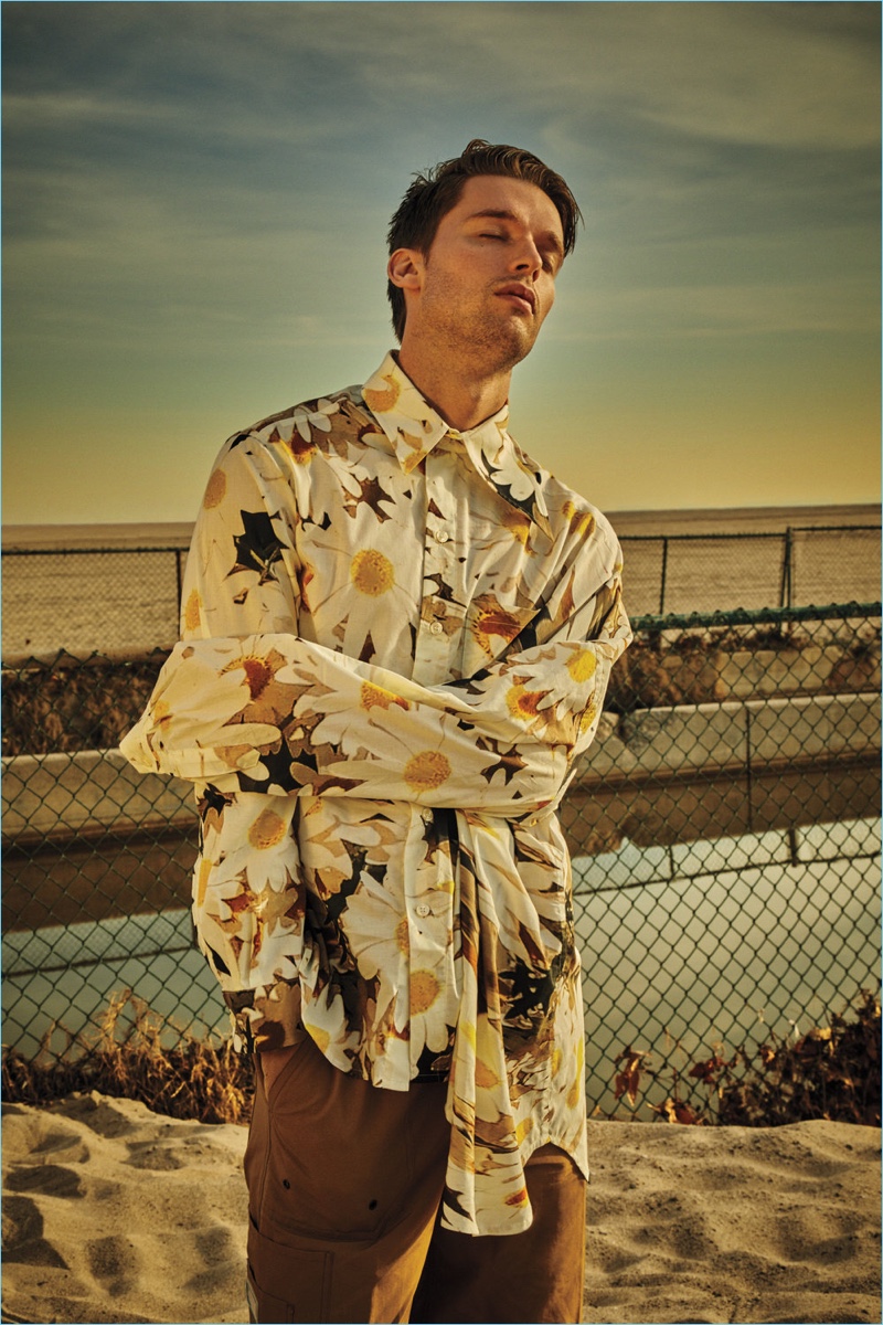 Basking in the sun, Patrick Schwarzenegger wears an Alex Mullins shirt and Lanvin pants.