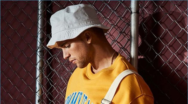 Brooklyn 90: River Viiperi Rocks Tommy Jeans for Simons Embracing 90s style, River Viiperi wears LE 31 overalls with a yellow Tommy Jeans sweatshirt. The model also rocks an Adidas Originals bucket hat.