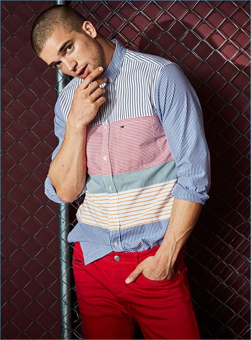 Model River Viiperi wears red Tommy Jeans denim with a Tommy Hilfiger shirt.
