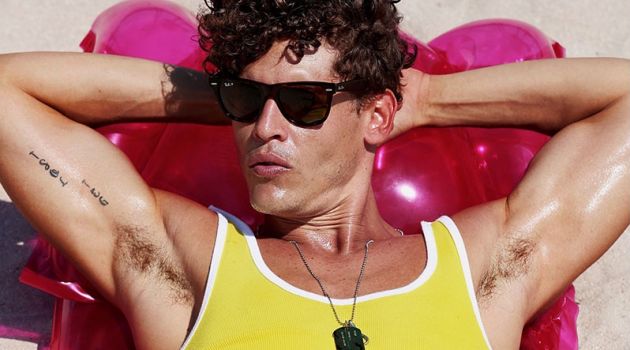 Sidney wears tank 2(X)ist, sunglasses Ray-Ban, and swimsuit Vilebrequin.