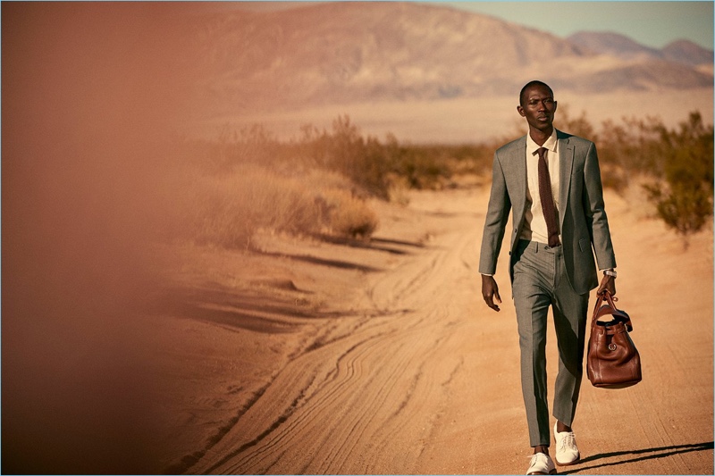 Taking to the desert, Armando Cabral dons a Todd Snyder White Label Sutton stretch tropical wool suit in light charcoal.