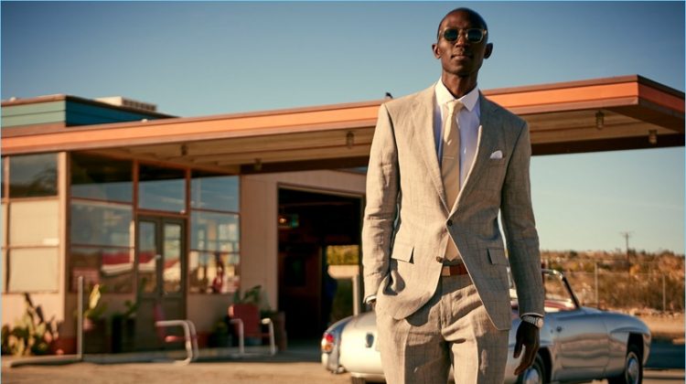 Looking sharp, Armando Cabral wears a Todd Snyder White Label Sutton windowpane linen suit in grey.