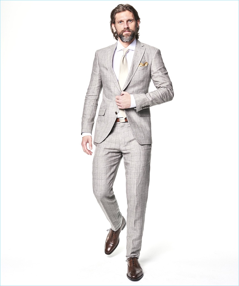 Tapping into a dapper edge, RJ Rogenski sports a Todd Snyder White Label Sutton windowpane linen suit in grey.