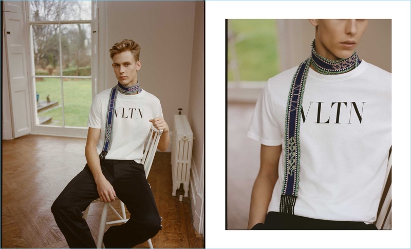 Making a case for logo fashions, Oliver Houlby wears a Valentino t-shirt. Valentino side-stripe track pants and a multicolored logo-intarsia belt (worn as scarf) complete his look.