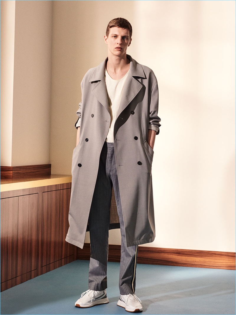 Tim Schuhmacher dons a trench and pinstripe pants by Zara Man.