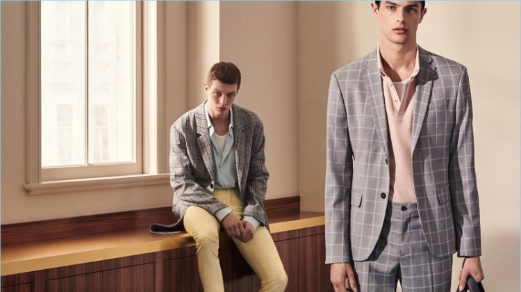 Models Tim Schuhmacher and Hannes Gobeyn don sleek suits by Zara Man.