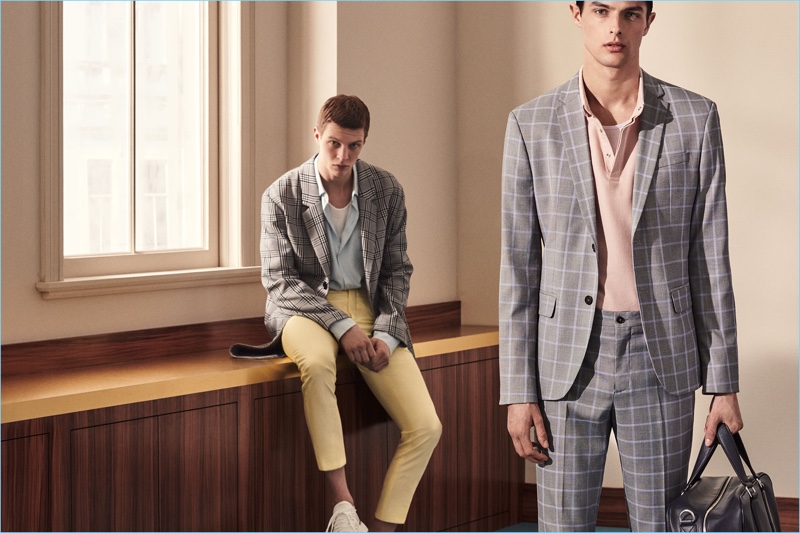 Models Tim Schuhmacher and Hannes Gobeyn don sleek suits by Zara Man.