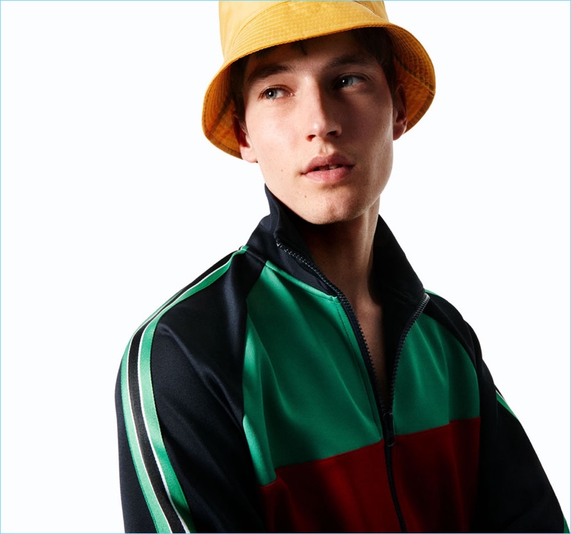 Connecting with Zara Man, Frederik Ruegger wears a color-block jacket with a bucket hat.