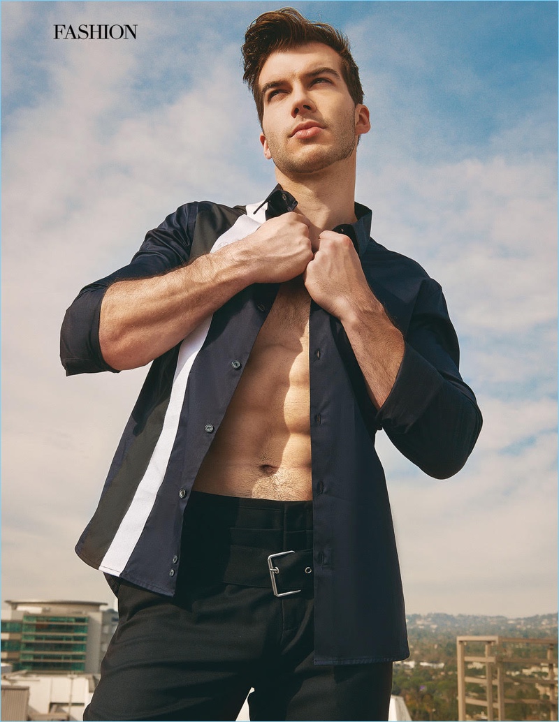 Appearing in a photo shoot, Adam Hagenbuch wears a Diesel shirt with Helmut Lang pants.