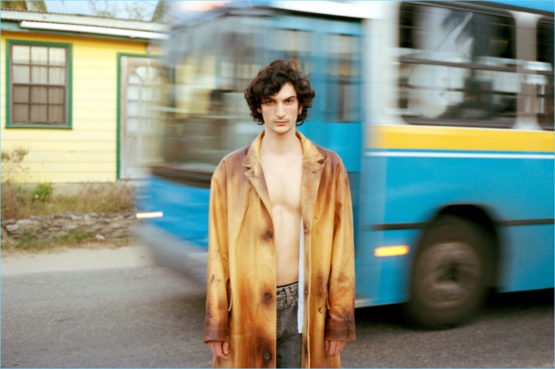 Model Luca Lemaire wears a Calvin Klein coat and Balenciaga jeans.