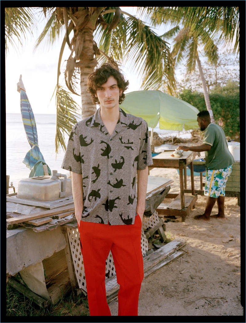 Luca Lemaire wears a Saint Laurent shirt with red Maison Margiela trousers.