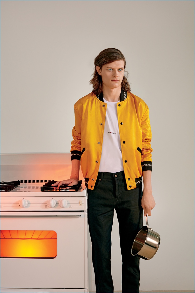 Charlie Tahan wears a Saint Laurent teddy jacket, logo t-shirt, and skinny jeans.