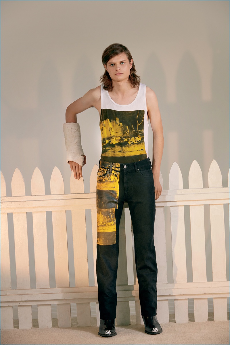 Connecting with Barneys New York, Charlie Tahan wears a tank, jeans, and boots by Calvin Klein 205W39NYC. 