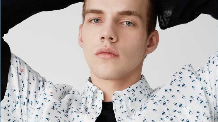 Benji Staker wears a short-sleeve flamingo print shirt from Club Monaco.