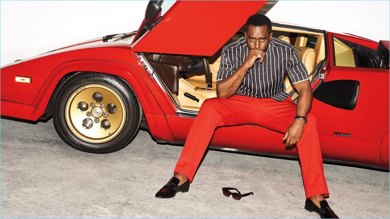Posing in a sports car, Diddy wears a Haider Ackermann shirt, Maison Margiela pants, and Christian Louboutin loafers. He also sports a Cartier watch.