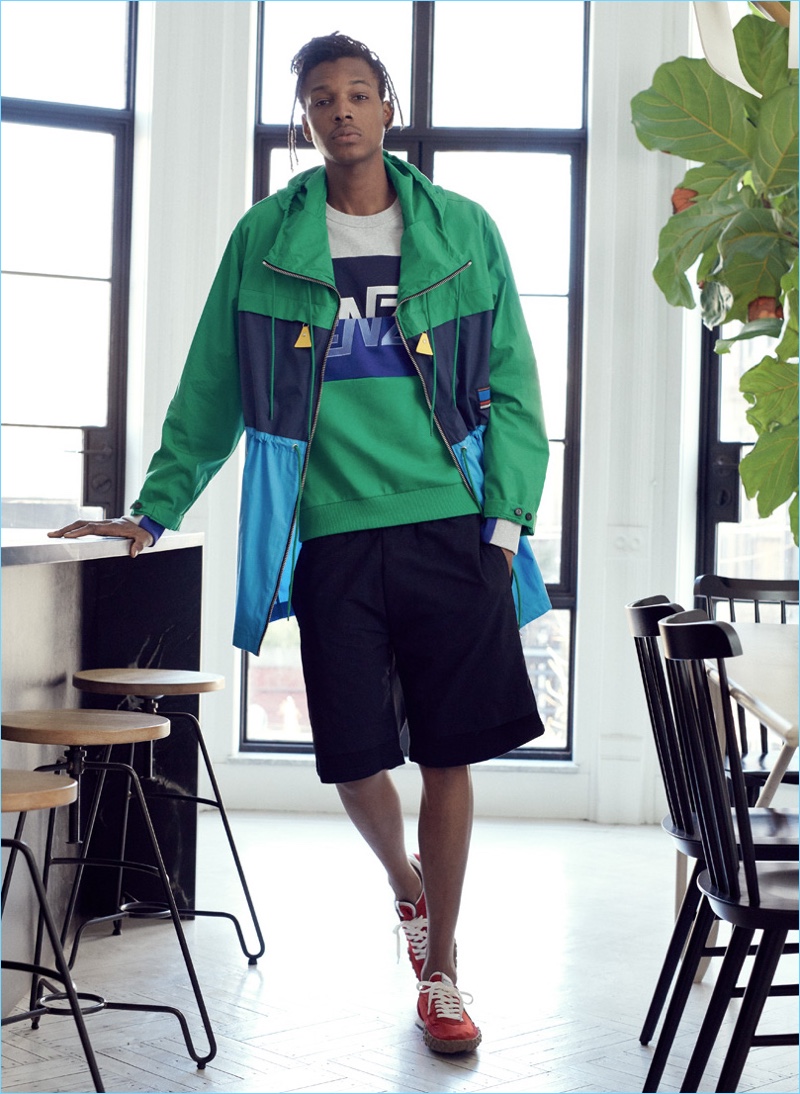 Going sporty, Matthew Davidson wears a parka, shorts, sweatshirt, and sneakers from Kenzo.