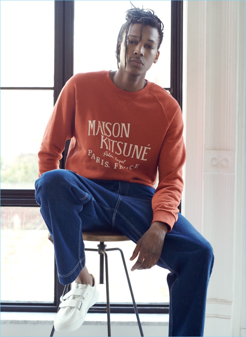 Sporting key essentials, Matthew Davidson sports a Maison Kitsune sweatshirt, AMI jeans, and Soloviere sneakers.