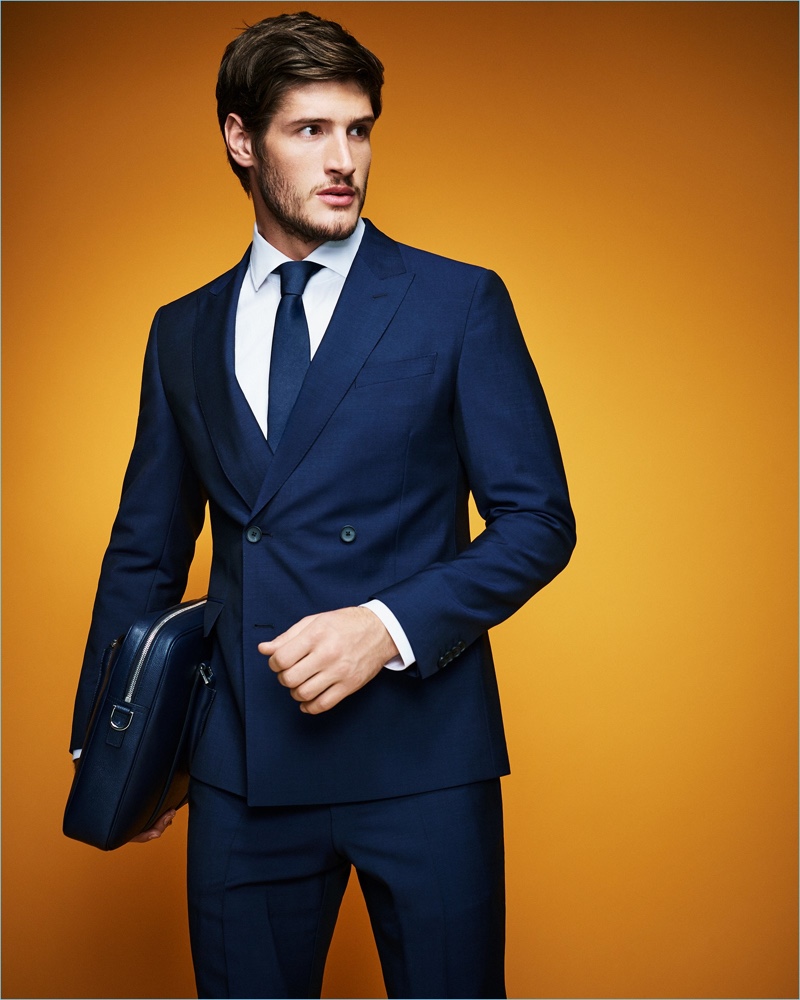 A sleek vision, Ryan Tift dons a navy BOSS wool/mohair suit.