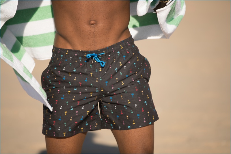 A multi-color print pops on a pair of black palm beach swim shorts by Happy Socks.