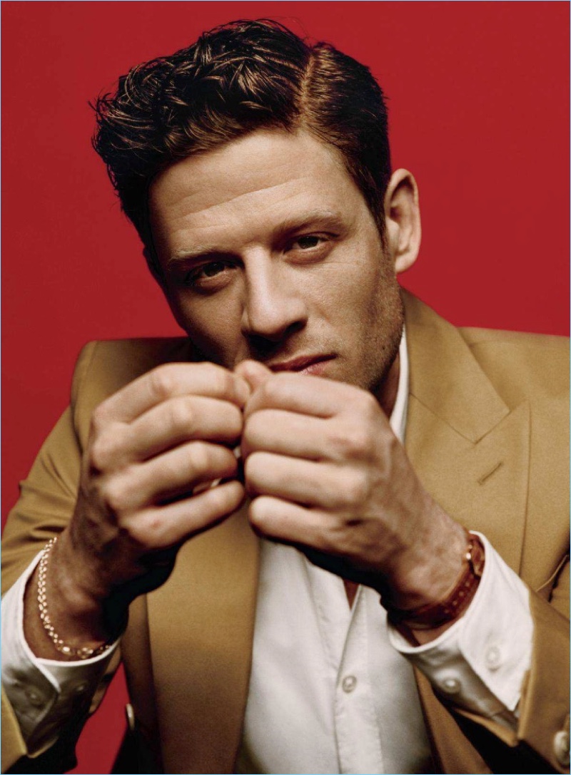 Starring in a stylish photo shoot, James Norton wears a BOSS shirt and jacket. He accessorizes with a Cartier watch and bracelet by The Great Frog.