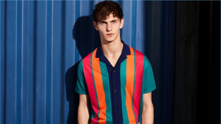 Luc Defont-Saviard rocks a bold multi-colored striped camp collar shirt from Zara Man.