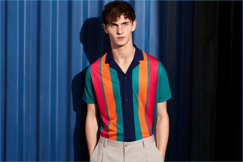 Luc Defont-Saviard rocks a bold multi-colored striped camp collar shirt from Zara Man.