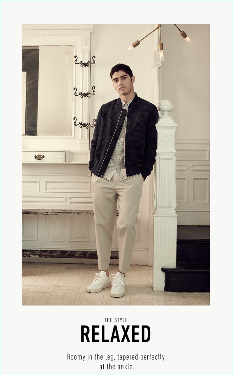 Torin Verdone wears a PS by Paul Smith bomber jacket and Veja sneakers. He also sports a short-sleeve shirt and chinos from Theory.