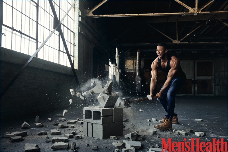 Starring in a Men's Health photo shoot, Michael B. Jordan wears a Calvin Klein tank with AG jeans and Timberland boots.