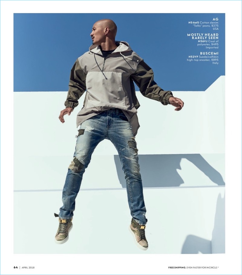 Leaping, Paolo Roldan sports AG denim jeans and Buscemi sneakers. 