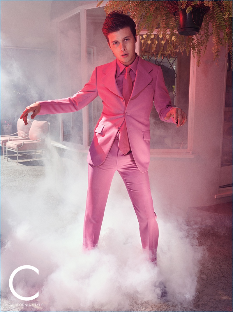 Showcasing his best dance moves, Nick Robinson wears a pink Gucci suit, shirt, and tie.