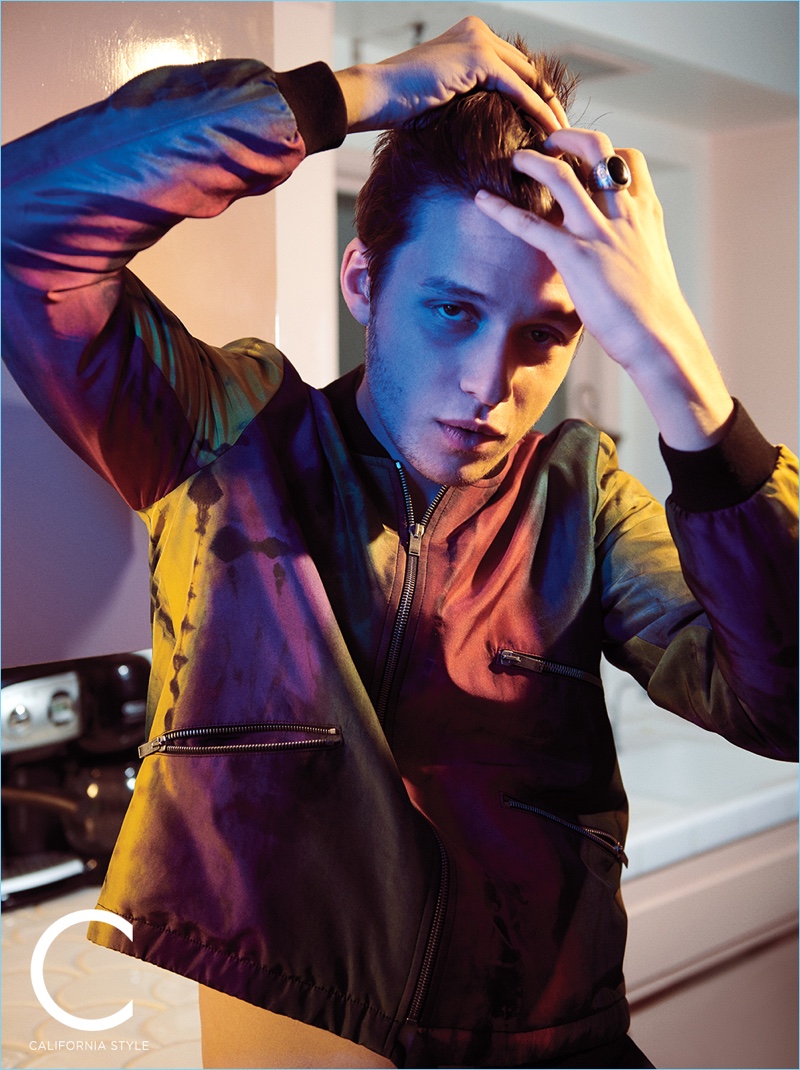 Fixing his hair, Nick Robinson wears a Saint Laurent bomber jacket.