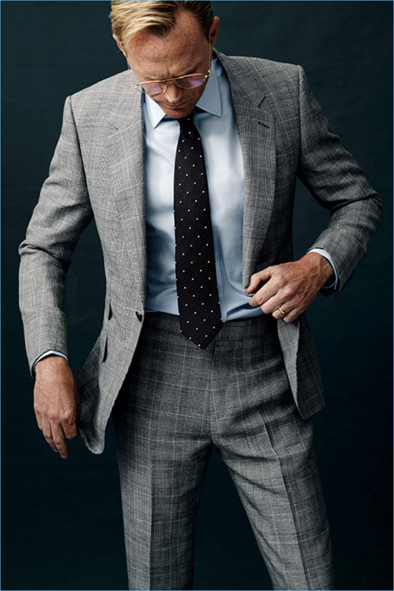 Dressed to impress, Paul Bettany wears a Kingsman grey Prince of Wales suit jacket and pants with a Kingsman + Turnbull & Asser herringbone shirt. Bettany also dons a Kingsman + Drake's polka dot tie and Kingsman + Cutler and Gross aviator-style optical glasses.