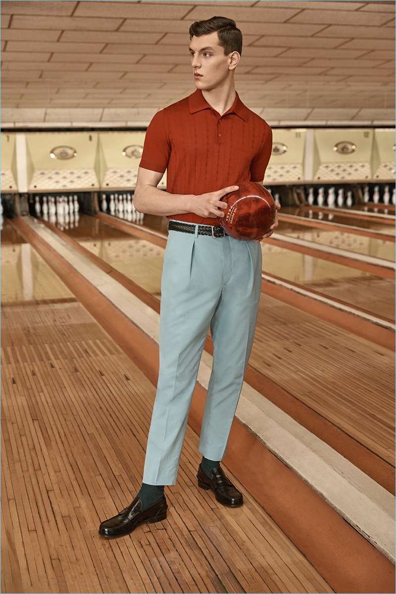 A smart vision, Luke Farley dons Prada's virgin wool polo with tapered trousers.