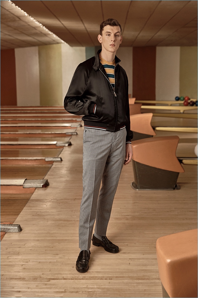 Making a statement, Luke Farley wears Prada's satin blouson jacket. 