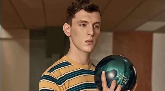 Luke Farley wears a striped t-shirt and gingham trousers from Prada's exclusive Mr Porter collection.