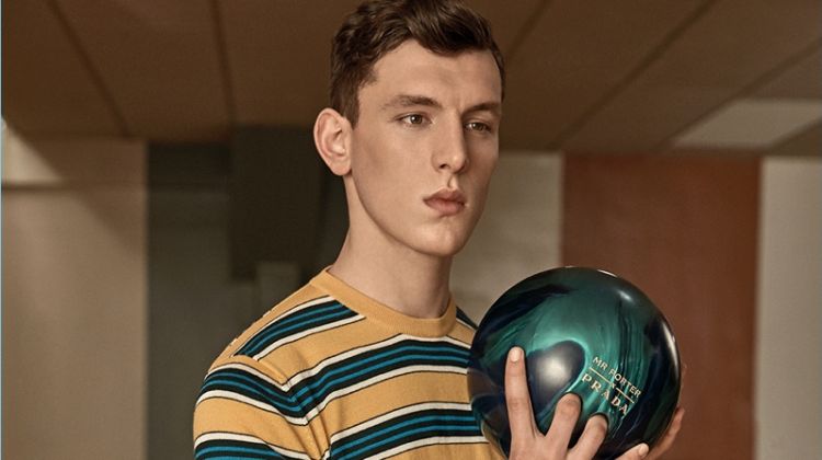 Luke Farley wears a striped t-shirt and gingham trousers from Prada's exclusive Mr Porter collection.