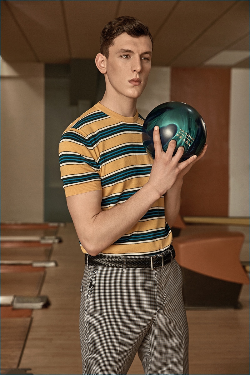 Luke Farley wears a striped t-shirt and gingham trousers from Prada's exclusive Mr Porter collection.