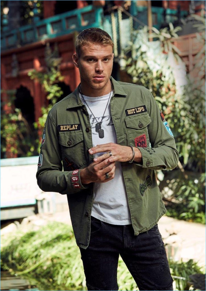 Embracing military-inspired style, Matthew Noszka sports a patch embellished shirt from Replay Jeans.