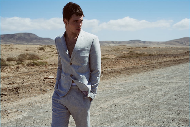 Donning a slim-fit suit in grey, Luka Isaac connects with Reserved for summer.